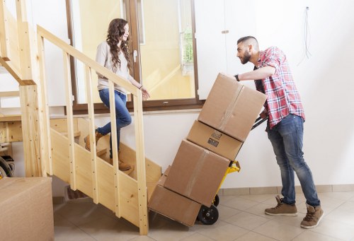 Workers using safe lifting techniques during a furniture move